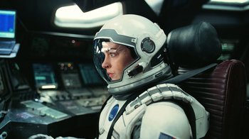 Movie still from “Interstellar” (2014), directed by Christopher Nolan – A person in a spacesuit and helmet in a space ship; Medium shot, Overhead angle