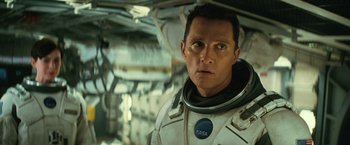 Movie still from “Interstellar” (2014), directed by Christopher Nolan – A person wearing a space suit; Close Up shot, Over the shoulder angle