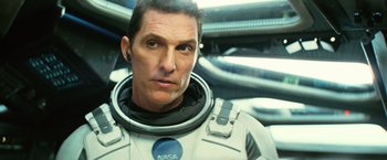 Movie still from “Interstellar” (2014), directed by Christopher Nolan – A person wearing a space suit; Close Up shot, Over the shoulder angle