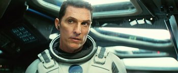 Movie still from “Interstellar” (2014), directed by Christopher Nolan – A person wearing a space suit; Close Up shot, Over the shoulder angle