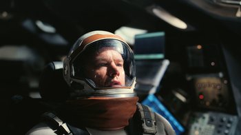 Movie still from “Interstellar” (2014), directed by Christopher Nolan – A man wearing a space suit and a helmet; Close Up shot, Overhead angle