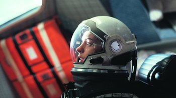 Movie still from “Interstellar” (2014), directed by Christopher Nolan – A woman wearing a space suit and a helmet; Medium shot, Low angle