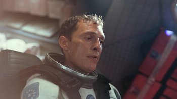 Movie still from “Interstellar” (2014), directed by Christopher Nolan – A person wearing a space suit; Close Up shot, Over the shoulder angle