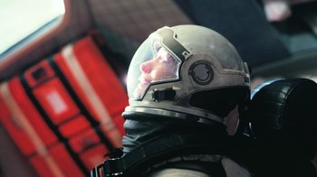 Movie still from “Interstellar” (2014), directed by Christopher Nolan – A man wearing a space suit and a helmet; Close Up shot, Low angle