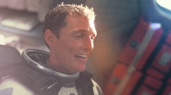 Movie still from “Interstellar” (2014), directed by Christopher Nolan – A person wearing a space suit; Close Up shot, Overhead angle