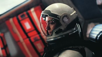 Movie still from “Interstellar” (2014), directed by Christopher Nolan – A person wearing a space suit and a helmet; Close Up shot, Low angle