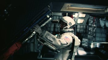 Movie still from “Interstellar” (2014), directed by Christopher Nolan – A man in a spacesuit is holding a ladder; Medium shot, Overhead angle