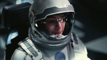 Movie still from “Interstellar” (2014), directed by Christopher Nolan – A person in a space suit with a helmet on; Close Up shot, Overhead angle