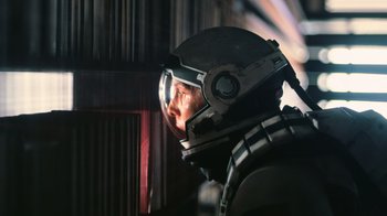 Movie still from “Interstellar” (2014), directed by Christopher Nolan – A man wearing a space suit and a helmet; Close Up shot, Low angle