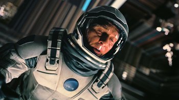 Movie still from “Interstellar” (2014), directed by Christopher Nolan – A man wearing a space suit and a helmet; Close Up shot, Overhead angle
