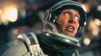 Movie still from “Interstellar” (2014), directed by Christopher Nolan – A person wearing a space suit; Close Up shot, Overhead angle