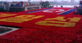 Movie still from “Into the Inferno” (2016), directed by Werner Herzog – A field full of red and yellow flowers; Extreme Wide shot, High angle