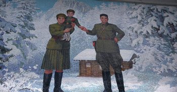 Movie still from “Into the Inferno” (2016), directed by Werner Herzog – A painting of two men and a child in military uniforms; Wide shot, Low angle