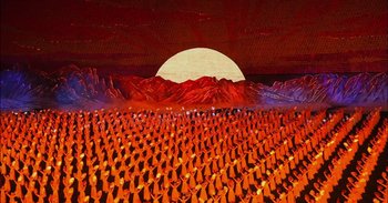 Movie still from “Into the Inferno” (2016), directed by Werner Herzog – A painting of a large group of people standing in front of a mountain; Extreme Wide shot, High angle