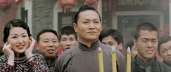 Movie still from “Ip Man” (2008), directed by Wilson Yip – A group of men standing next to each other holding pencils; Close Up shot, Low angle