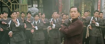 Movie still from “Ip Man” (2008), directed by Wilson Yip – A group of men standing in front of each other; Medium shot, Low angle