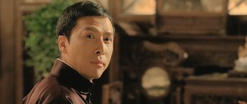 Movie still from “Ip Man” (2008), directed by Wilson Yip – A person wearing a shirt and tie; Close Up shot, Low angle