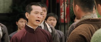 Movie still from “Ip Man” (2008), directed by Wilson Yip – A group of men standing next to each other; Close Up shot, Over the shoulder angle