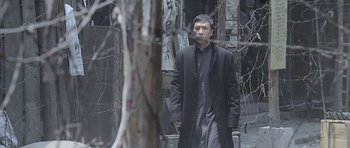 Movie still from “Ip Man” (2008), directed by Wilson Yip – A man standing in front of a bare tree; Medium shot, High angle