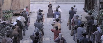 Movie still from “Ip Man” (2008), directed by Wilson Yip – A group of people standing in a courtyard; Wide shot, High angle