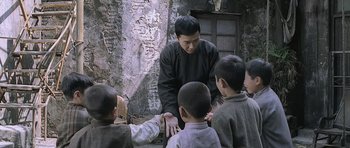 Movie still from “Ip Man” (2008), directed by Wilson Yip – A group of young boys standing next to each other; Medium shot, Over the shoulder angle