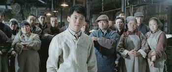 Movie still from “Ip Man” (2008), directed by Wilson Yip – A group of men standing in a room; Medium shot, Low angle