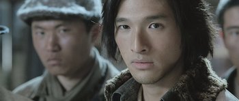 Movie still from “Ip Man” (2008), directed by Wilson Yip – A person wearing a hat and looking at the camera; Close Up shot, Low angle