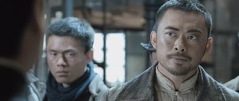 Movie still from “Ip Man” (2008), directed by Wilson Yip – A man in a brown jacket and a man in a black jacket; Close Up shot, Over the shoulder angle