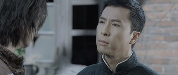 Movie still from “Ip Man” (2008), directed by Wilson Yip – A person looking at something; Close Up shot, Low angle