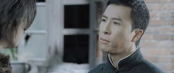 Movie still from “Ip Man” (2008), directed by Wilson Yip – A person looking at something; Close Up shot, Low angle