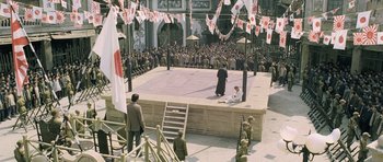 Movie still from “Ip Man” (2008), directed by Wilson Yip – An audience watching a performance in an open - air theater; Extreme Wide shot, High angle