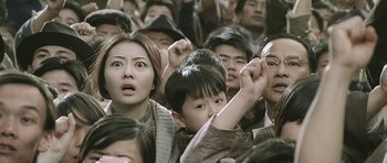 Movie still from “Ip Man” (2008), directed by Wilson Yip – A group of people standing in a room; Medium shot, High angle