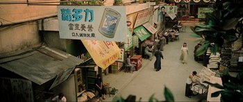 Movie still from “Ip Man 2” (2010), directed by Wilson Yip – A group of people walking down a street next to buildings; Extreme Wide shot, High angle