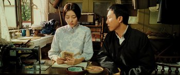 Movie still from “Ip Man 2” (2010), directed by Wilson Yip – A man and a woman sitting at a table; Medium shot, Over the shoulder angle