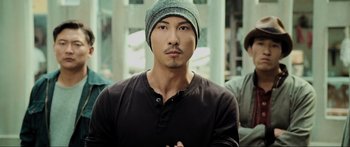 Movie still from “Ip Man 2” (2010), directed by Wilson Yip – A person wearing a hat; Close Up shot, Over the shoulder angle