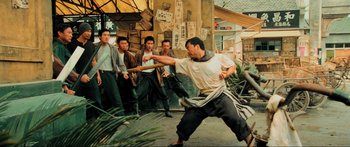 Movie still from “Ip Man 2” (2010), directed by Wilson Yip – A group of men standing around a building; Wide shot, Low angle