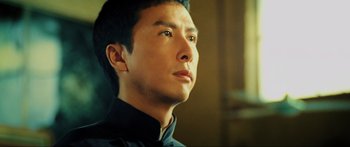 Movie still from “Ip Man 2” (2010), directed by Wilson Yip – A person wearing a black shirt; Close Up shot, Low angle