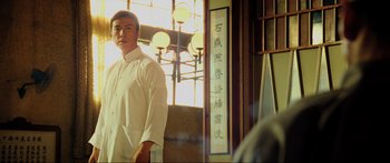 Movie still from “Ip Man 2” (2010), directed by Wilson Yip – A man standing in front of a mirror in a restaurant; Medium shot, Low angle