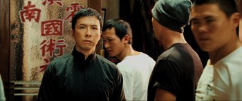 Movie still from “Ip Man 2” (2010), directed by Wilson Yip – A group of men standing next to each other in front of a mirror; Close Up shot, Over the shoulder angle