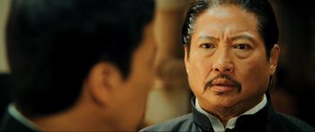 Movie still from “Ip Man 2” (2010), directed by Wilson Yip – A person talking to another person; Close Up shot, Over the shoulder angle