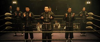 Movie still from “Ip Man 2” (2010), directed by Wilson Yip – A group of men standing in a boxing ring; Wide shot, Low angle