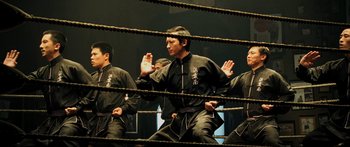 Movie still from “Ip Man 2” (2010), directed by Wilson Yip – A group of men in a boxing ring; Medium shot, Low angle