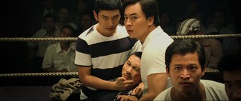 Movie still from “Ip Man 2” (2010), directed by Wilson Yip – A group of men standing next to each other in a room; Medium shot, High angle