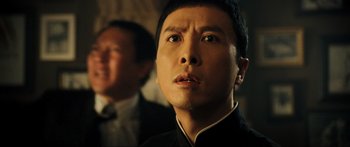Movie still from “Ip Man 2” (2010), directed by Wilson Yip – A person looking at the camera; Close Up shot, Low angle