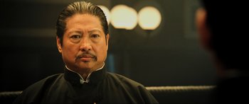 Movie still from “Ip Man 2” (2010), directed by Wilson Yip – A person wearing a black shirt; Close Up shot, Low angle