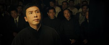 Movie still from “Ip Man 2” (2010), directed by Wilson Yip – A group of people in a dark room; Close Up shot, Low angle