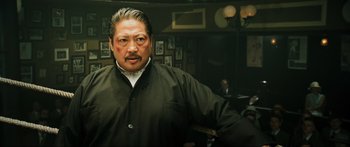 Movie still from “Ip Man 2” (2010), directed by Wilson Yip – A person in a room; Close Up shot, Low angle