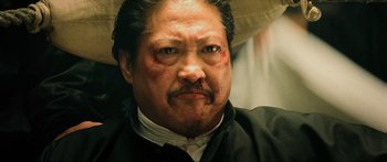 Movie still from “Ip Man 2” (2010), directed by Wilson Yip – A person wearing a black shirt; Close Up shot, Low angle