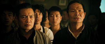 Movie still from “Ip Man 2” (2010), directed by Wilson Yip – A group of men standing next to each other in a room; Close Up shot, Low angle