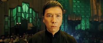 Movie still from “Ip Man 2” (2010), directed by Wilson Yip – A person wearing a black shirt; Close Up shot, Low angle